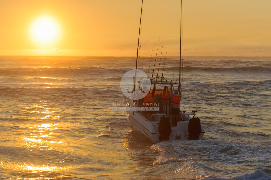 "Fishing boat launching at sunrise" by Justin Klusener - £24.00 "Fishing boat launching at sunrise" stock image