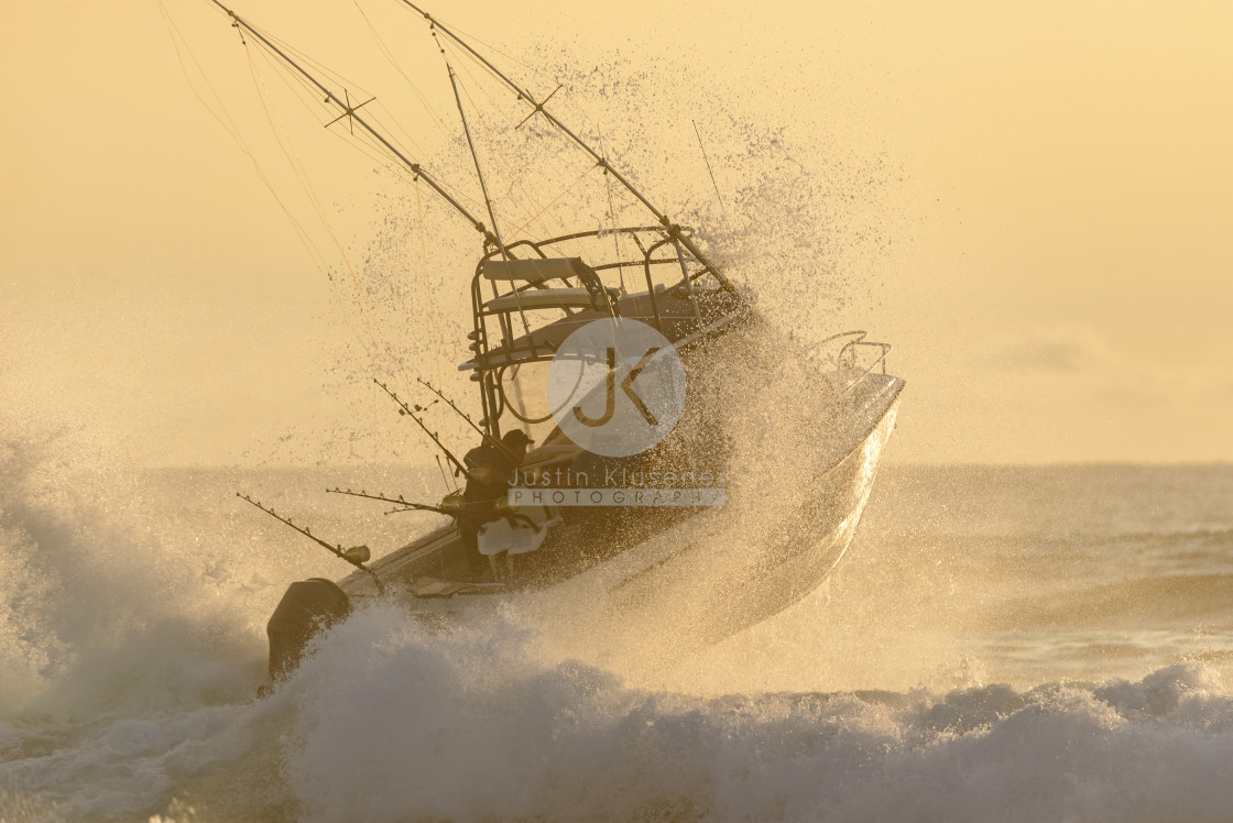 "Fishing ski boat punching through a wave" by Justin Klusener - £24.00 "Fishing ski boat punching through a wave" stock image