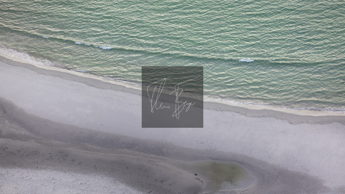 "The white beach seen from above as it fades into the ocean." stock image