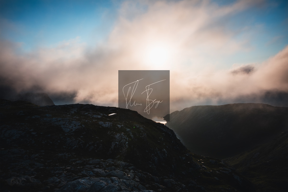 "A sunset behind the clouds laying above the Vetvika bay a summer evening in Bremanger, Norway." stock image