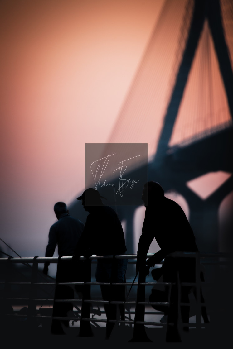 "Fishermen of Cadiz - fishing in front of La Pepa bridge in Cadiz during sunrise." stock image