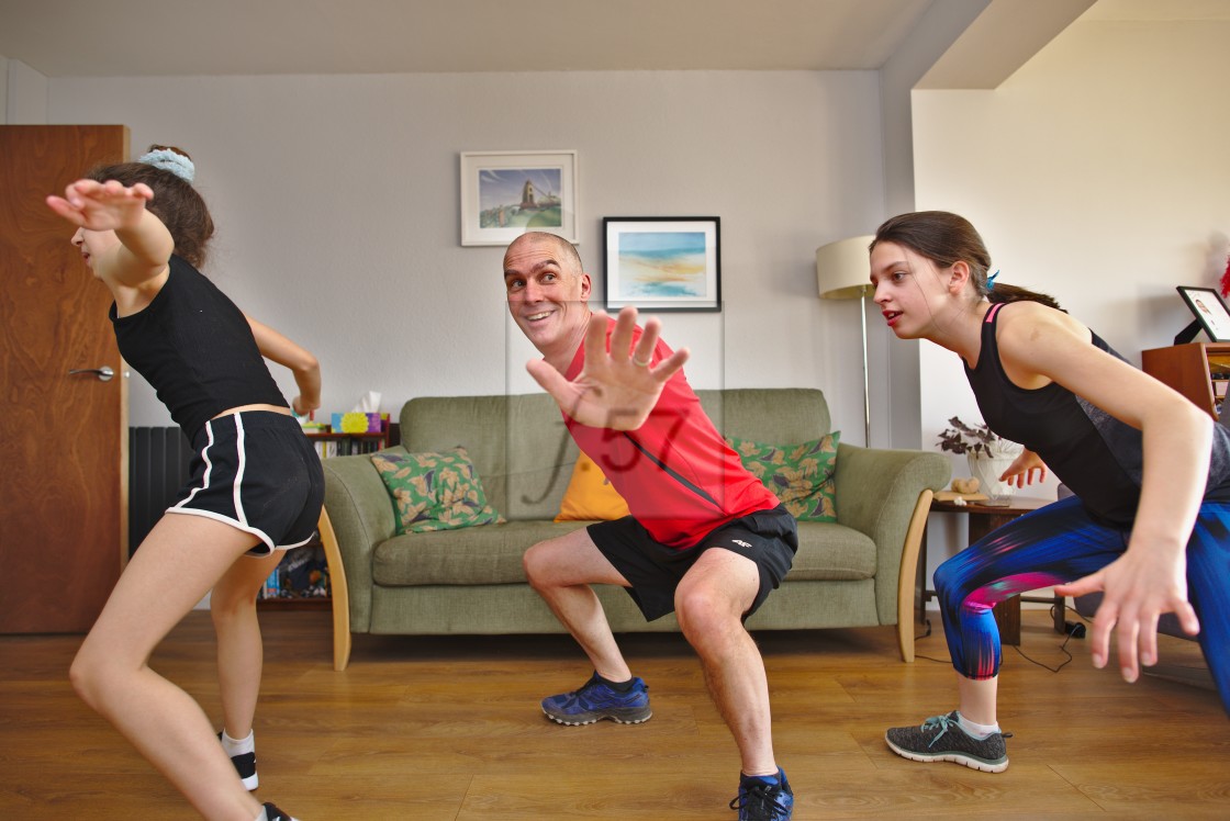 "A family follow an online exercise class working out together at home" by HD57 lifestyle stock photography - $25.11 "A family follow an online exercise class working out together at home" stock image