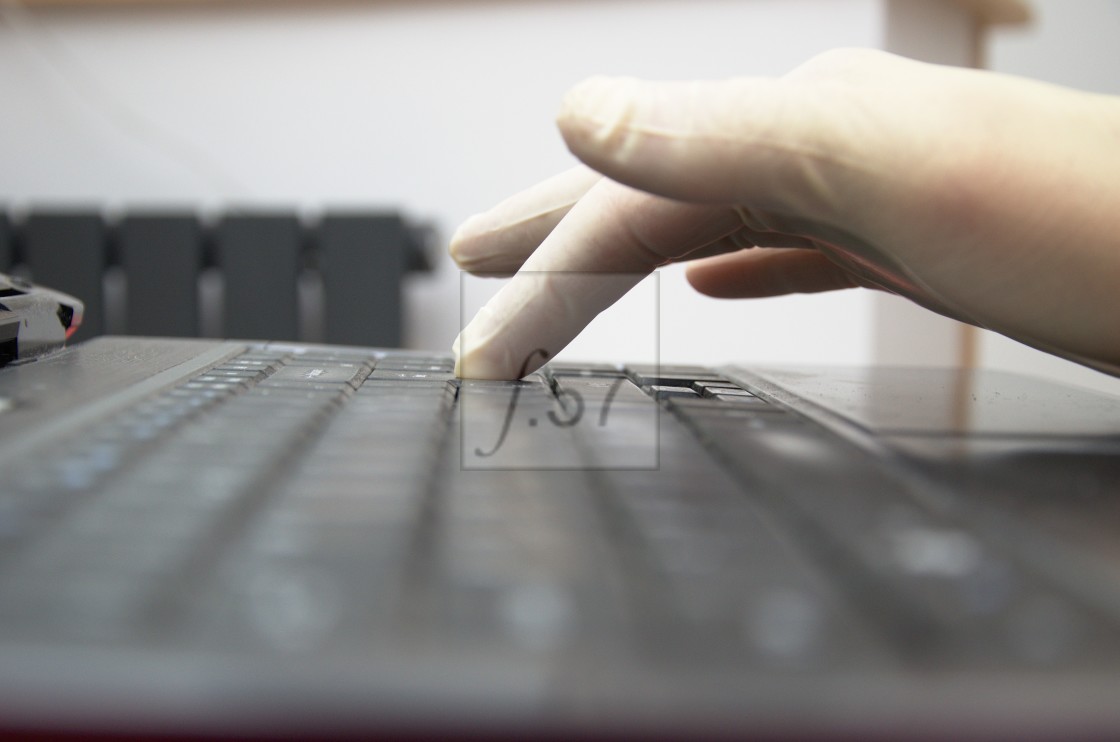 "Wearing latex gloves PPE to safely use a computer keyboard" by HD57 lifestyle stock photography - $25.11 "Wearing latex gloves PPE to safely use a computer keyboard" stock image
