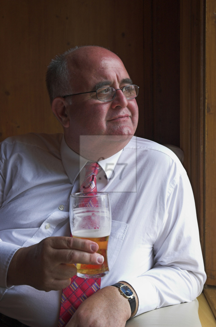 "Stock photo of man in a pub enjoying a beer" stock image