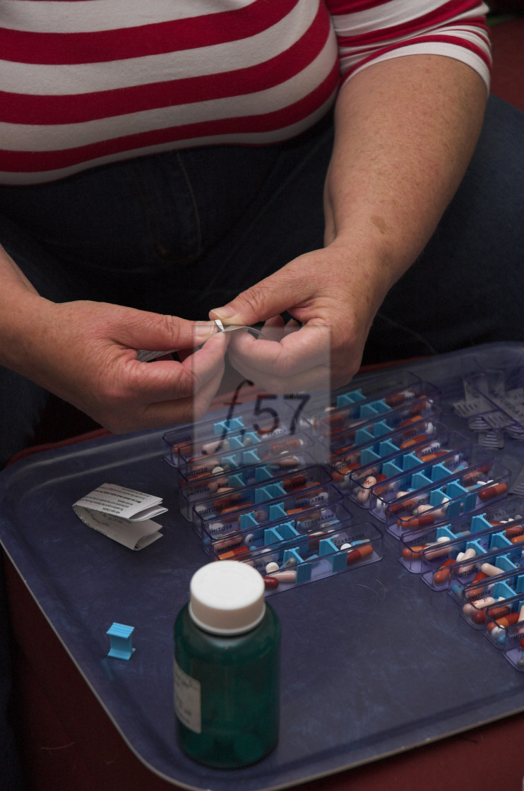 "Carer peparing medication" stock image