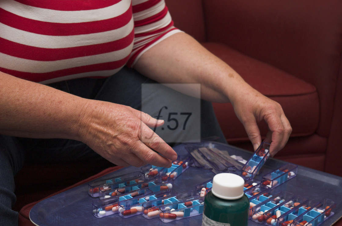 "Carer peparing medication" stock image