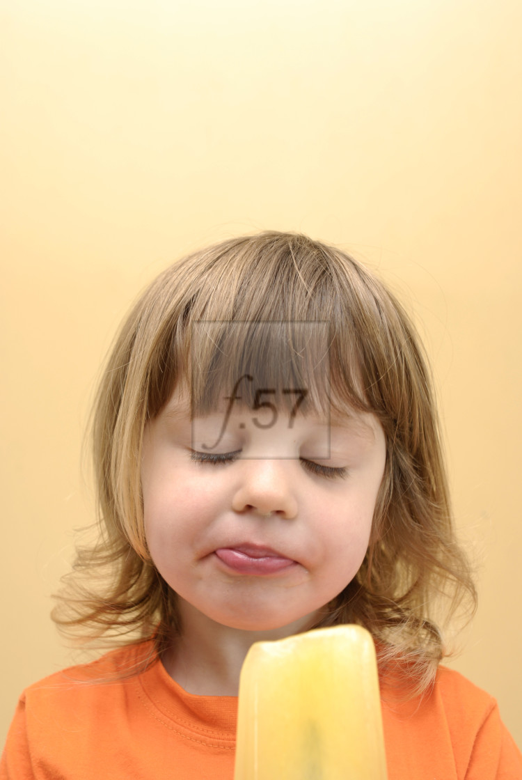 "Girl eating frozen ice lolly" stock image