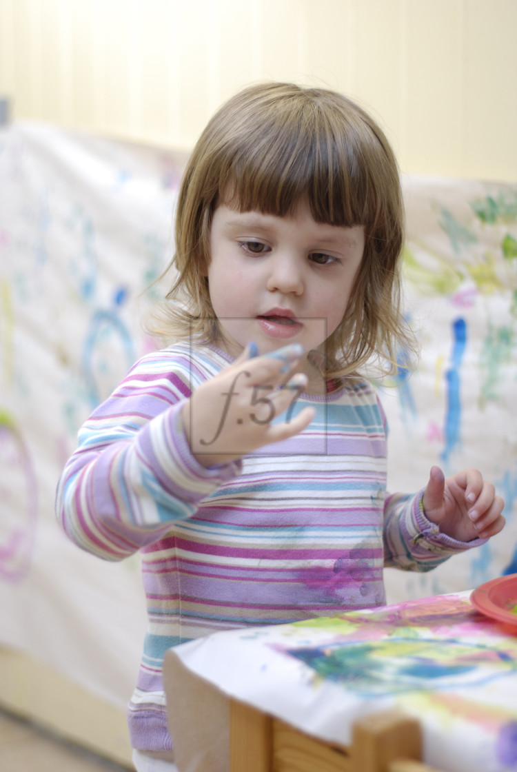 "Young three year old girl painting" stock image