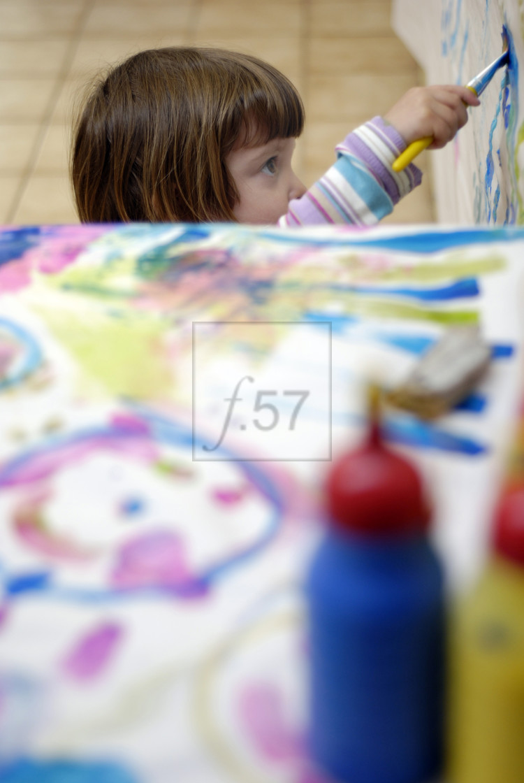 "Young three year old girl painting" stock image