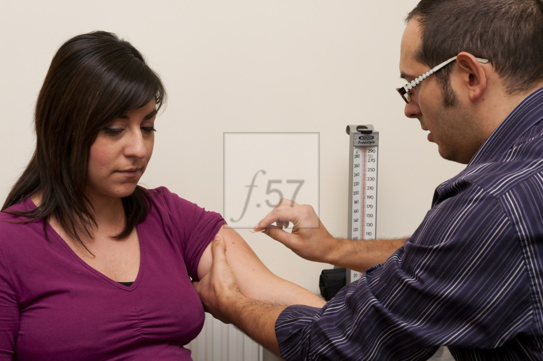 "GP Doctor preparing to give patient a vaccination" stock image