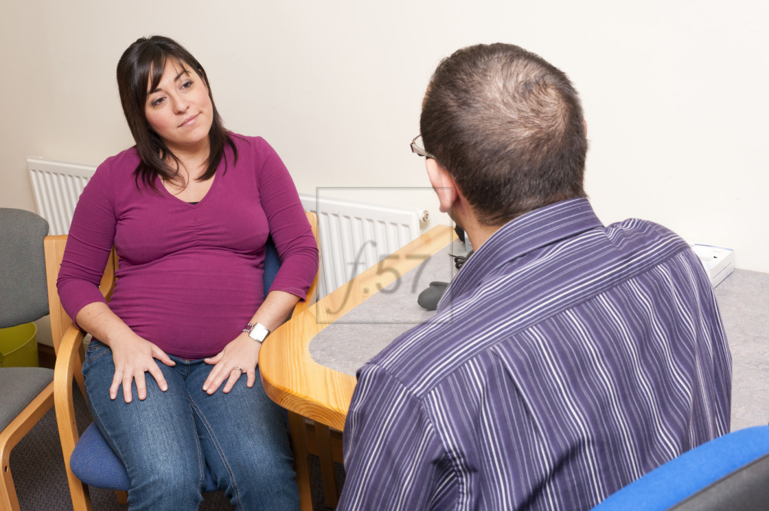 "GP Doctor surgery patient consultation with pregnant woman." stock image