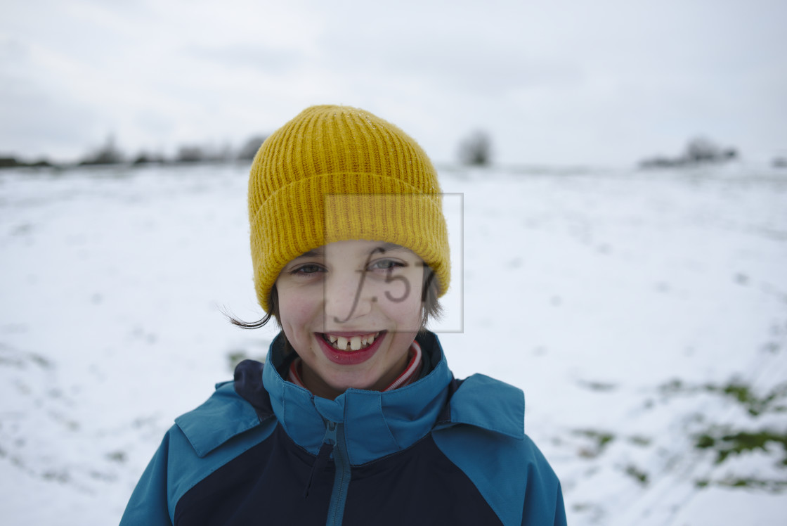 "Portrait of child out in winter snow field wearing a woolen bobble hat" by HD57 lifestyle stock photography - $29.37 "Portrait of child out in winter snow field wearing a woolen bobble hat" stock image
