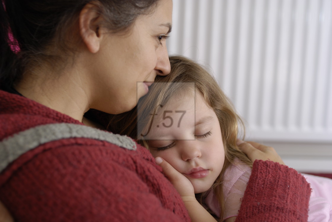 "Mother cuddling young three year old daughter asleep on her lap." by HD57 lifestyle stock photography - $29.40 "Mother cuddling young three year old daughter asleep on her lap." stock image