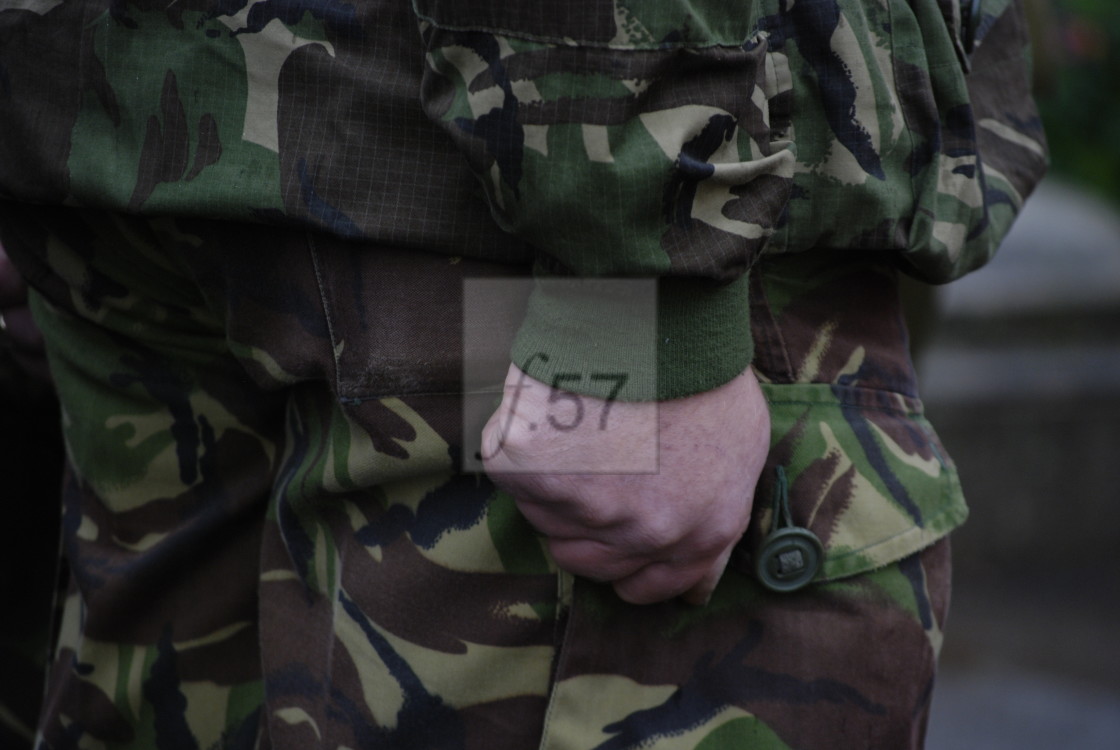 "Soldier in military fatigues standing to attention. Detail of clenched fist held at his side." by HD57 lifestyle stock photography - $29.37 "Soldier in military fatigues standing to attention. Detail of clenched fist held at his side." stock image