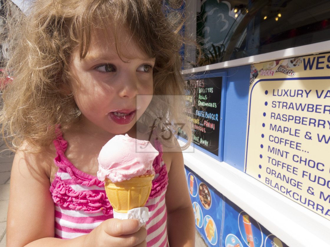 "Four year old girl enjoying a strawberry ice cream. Ilfracombe Devon." by HD57 lifestyle stock photography - $29.40 "Four year old girl enjoying a strawberry ice cream. Ilfracombe Devon." stock image