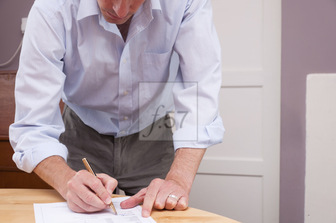 "Signing contract paperwork documents" stock image