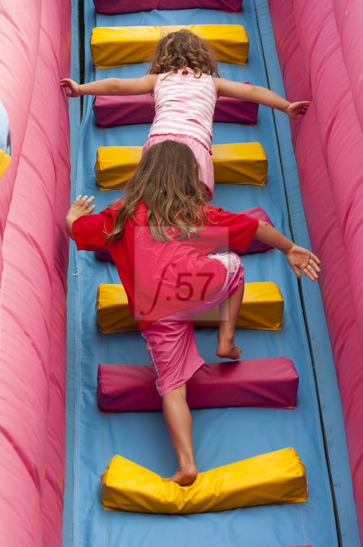 "Children running up stair on an inflatable slide." stock image