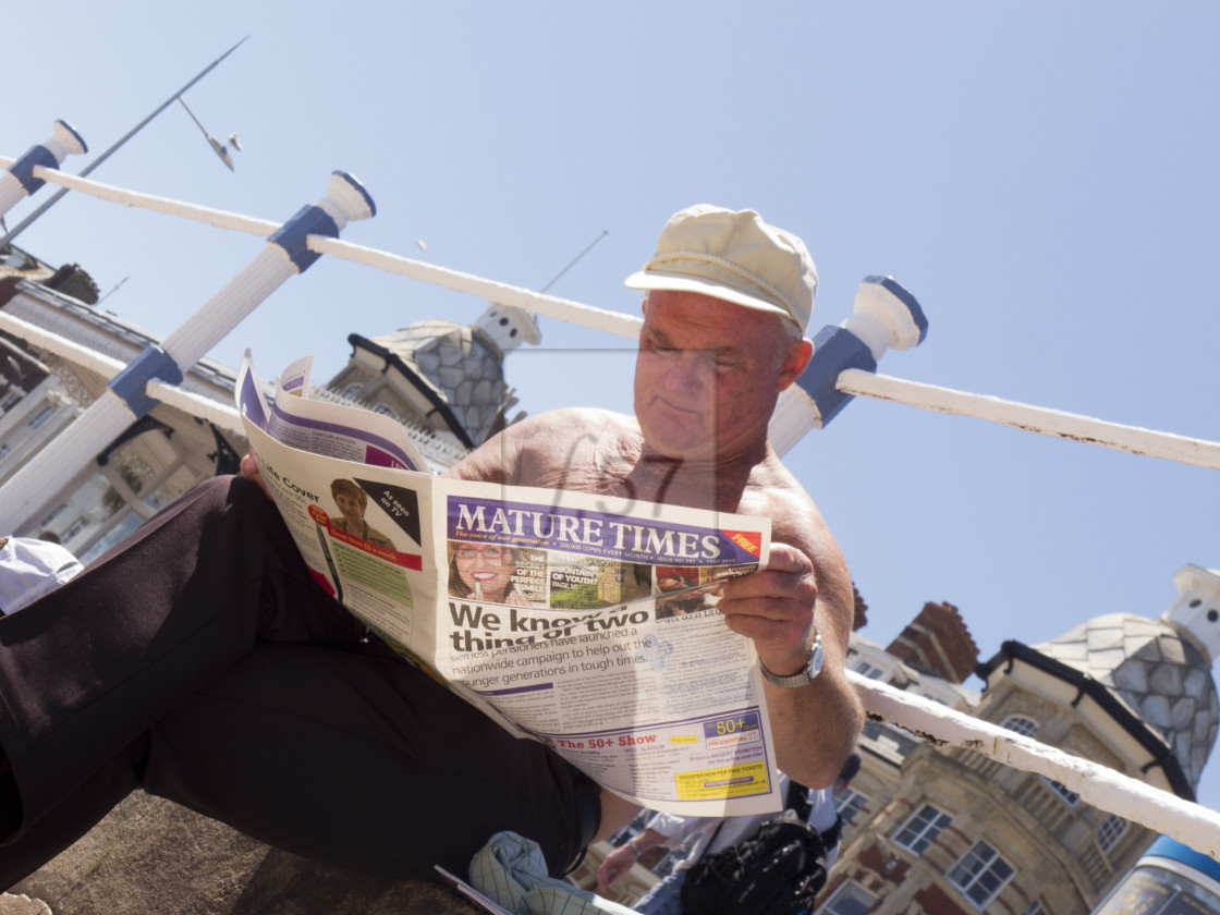 "Senior Man reading Mature Times newspaper" stock image