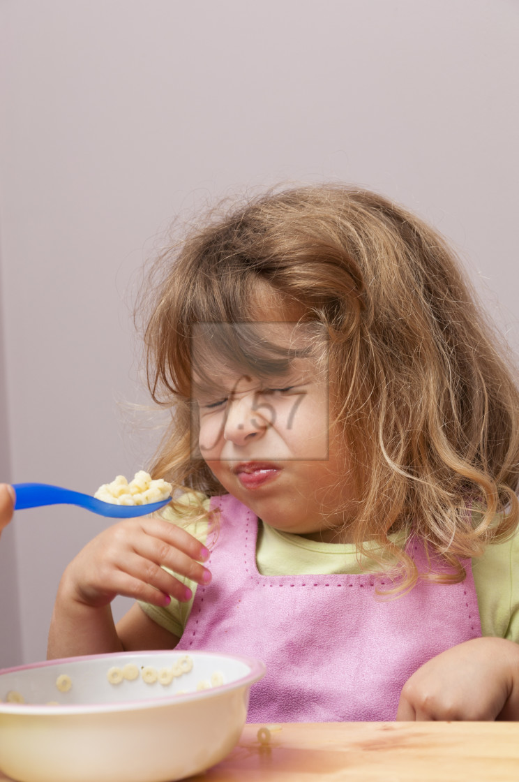 "Fussy eater. Mother trying to feed her four year old daughter." stock image