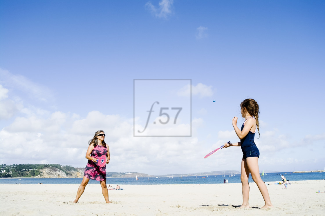 "Mother and daughter playing beach bat and ball, Morgat, Brittany, France." stock image