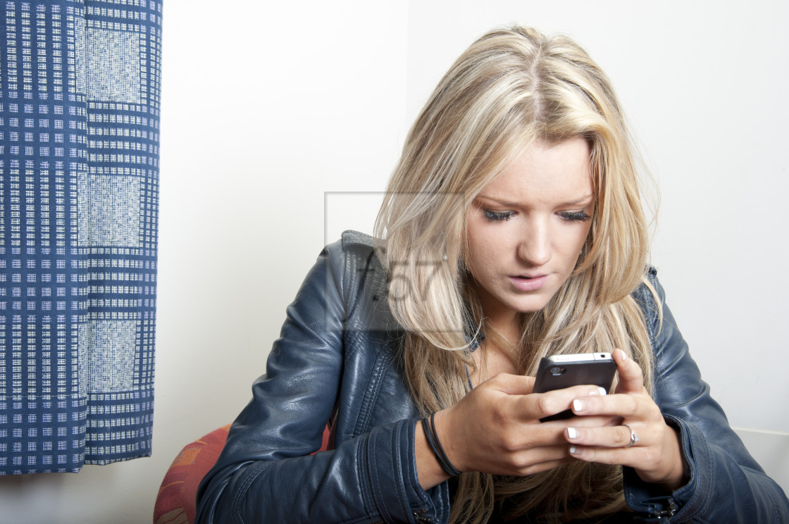 "Young woman using mobile phone" stock image