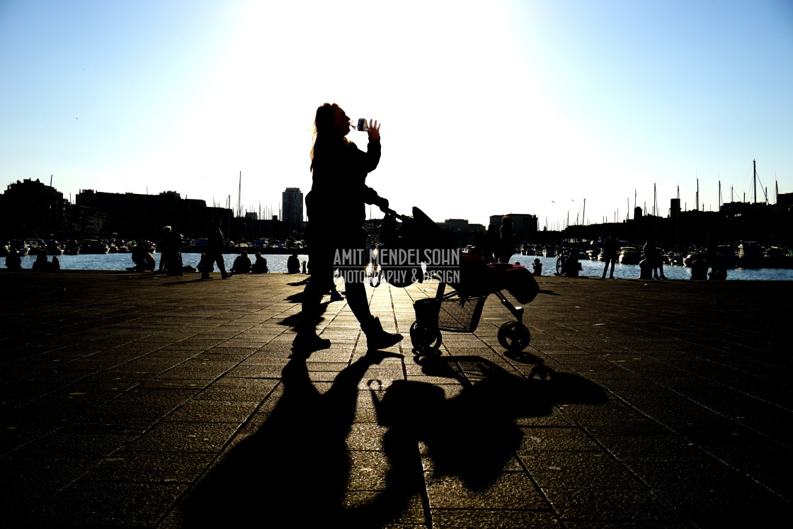 "silhouette of a woman pushing a baby" stock image