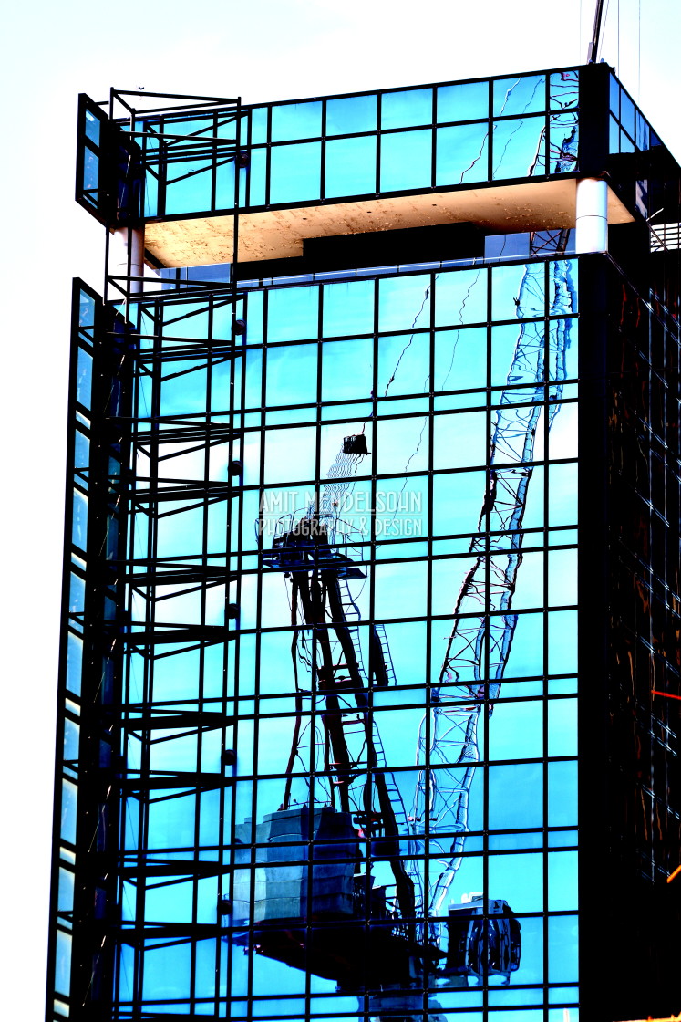 "A reflection of a crane on a building" stock image