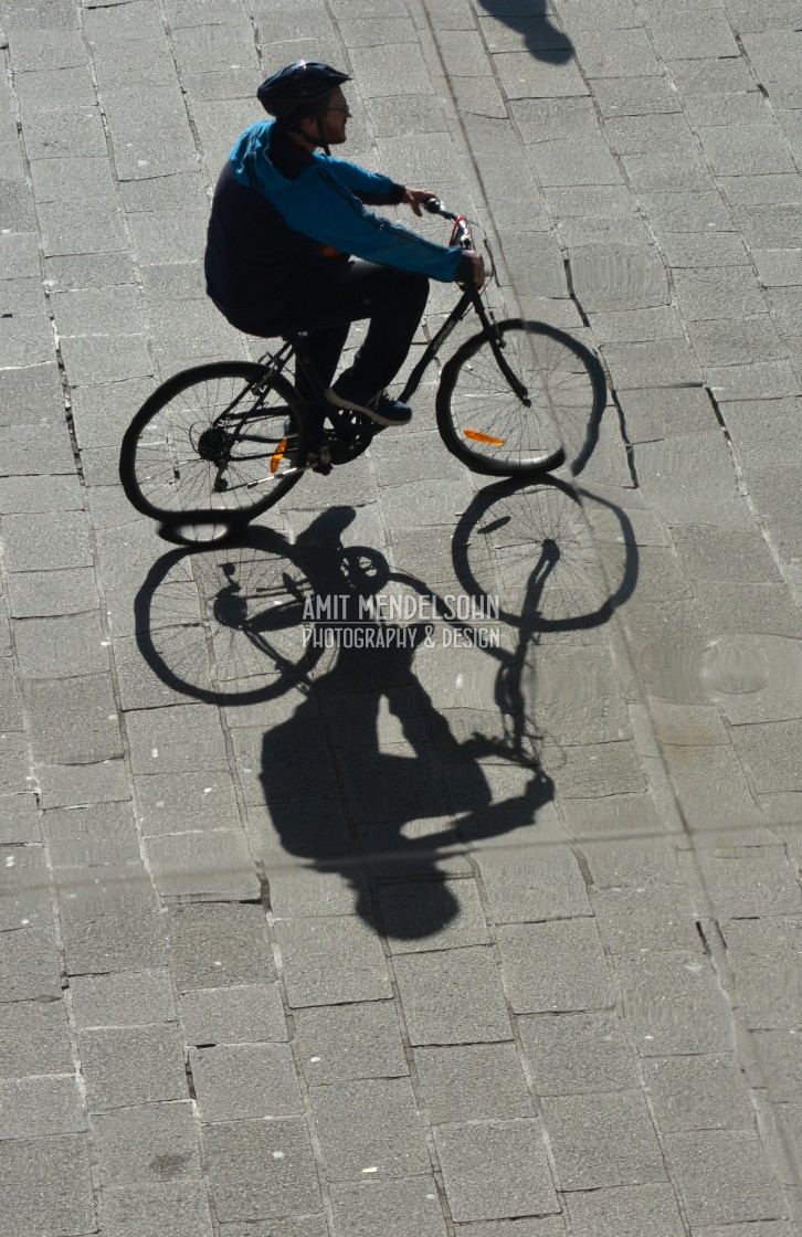 "A bicycle rider with his shadow" stock image