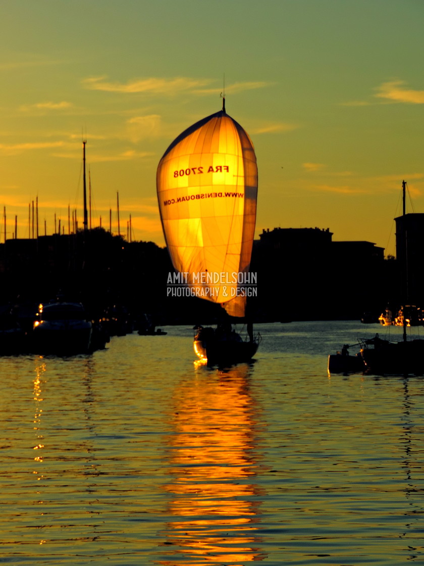 "A boat sailing with the sun" stock image