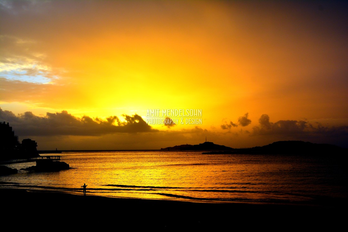 "A man on the beach in the sunset" stock image