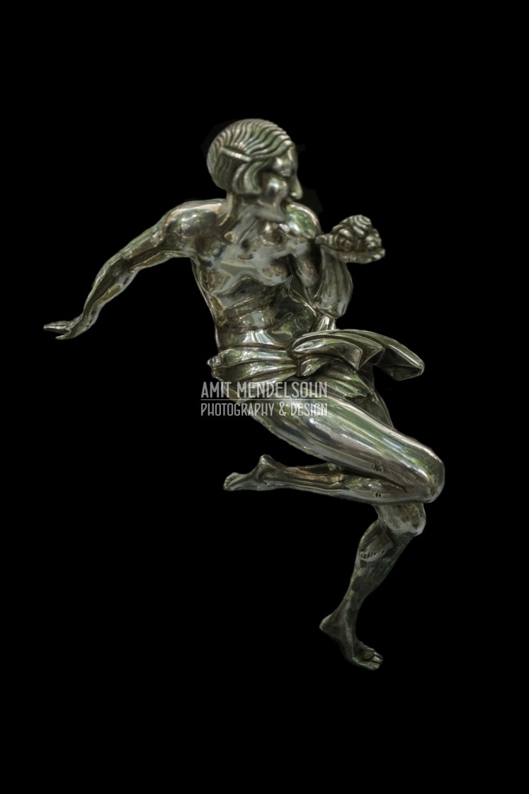 "an art deco statue of a woman dancing" stock image