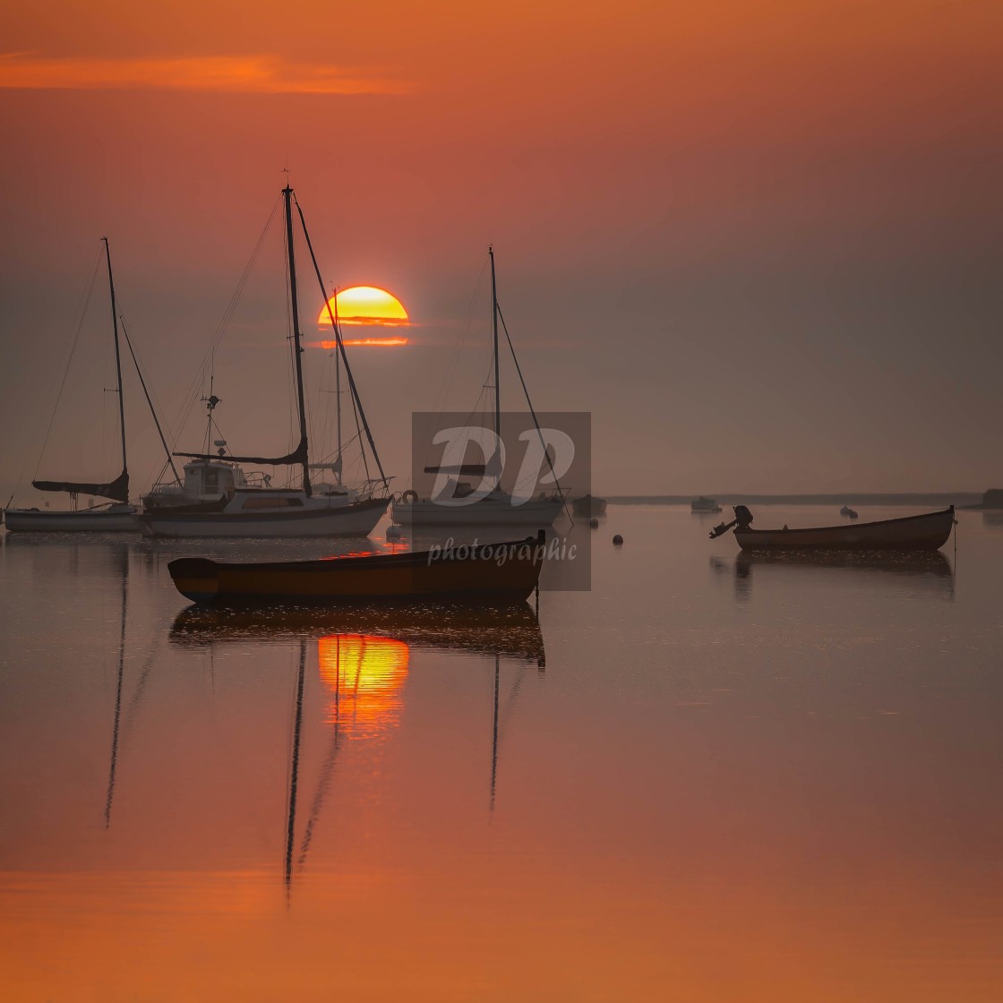 "Rising sun at Brancaster Staithe Norfolk" stock image