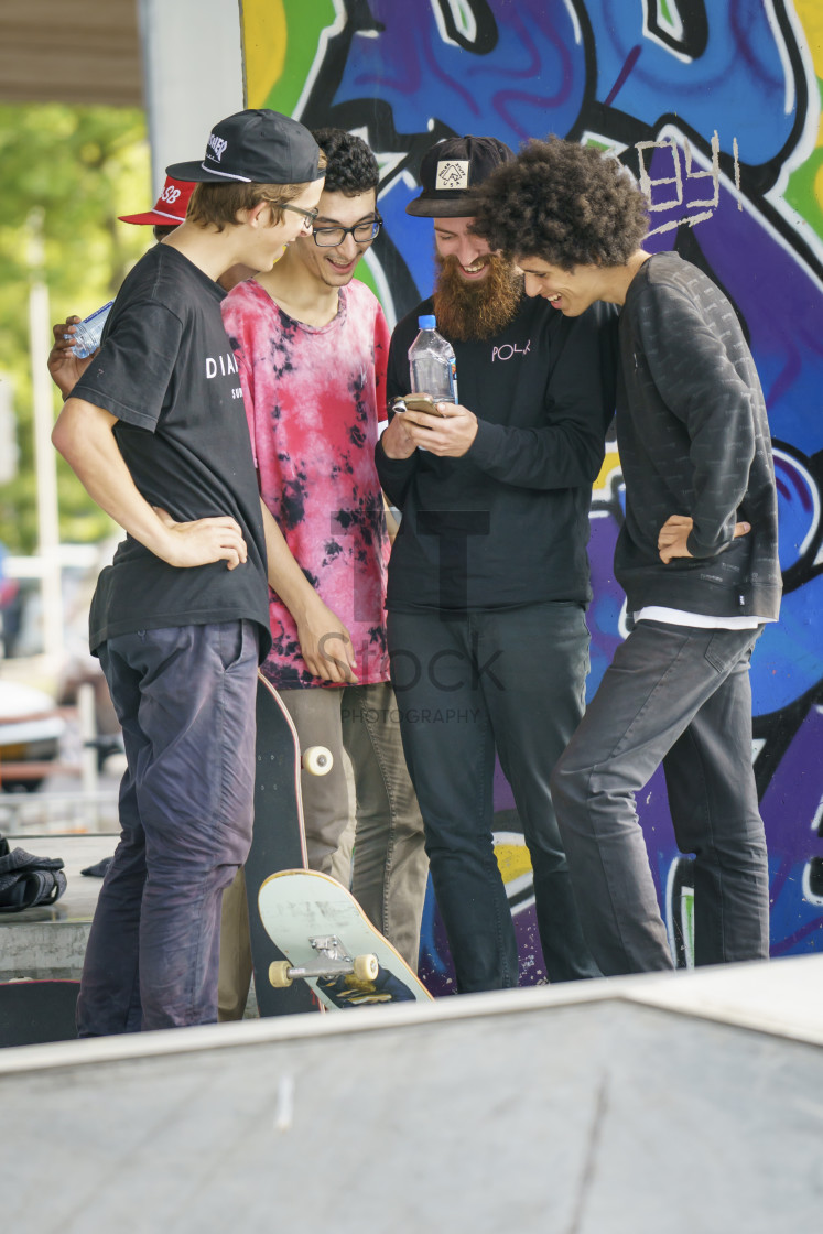 "Skateboarders checking mobile" by TTStock - $7.32 "Skateboarders checking mobile" stock image