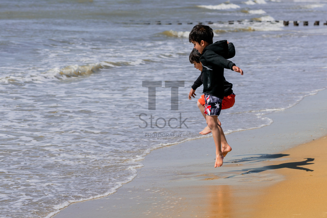 "Two young kids jumping." by TTStock - $7.32 "Two young kids jumping." stock image