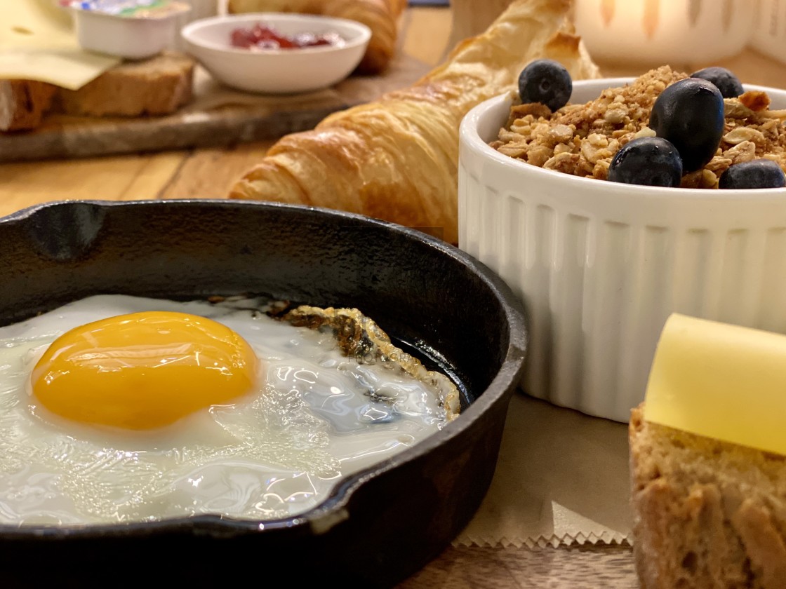 "Breakfast brunch warm food in restaurant, fried egg, cheese, croissant and fresh berries in bowl." by TTStock - $4.88 "Breakfast brunch warm food in restaurant, fried egg, cheese, croissant and fresh berries in bowl." stock image