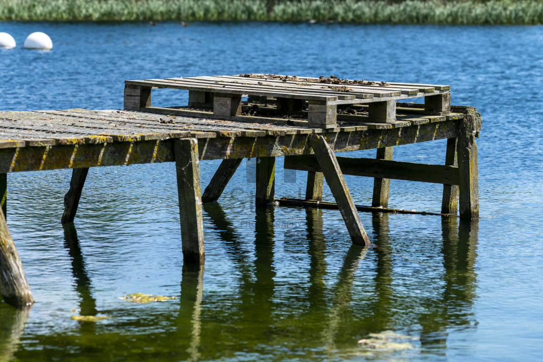 "Old wooden jetty on blue water" by TTStock - $5.05 "Old wooden jetty on blue water" stock image
