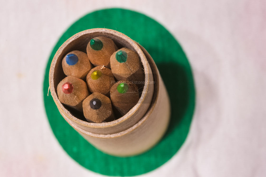 "Colored pencils inserted in a cardboard cylinder on a colored pl" by Brambilla Simone - £6.87 "Colored pencils inserted in a cardboard cylinder on a colored pl" stock image