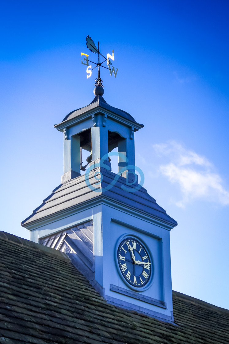 "Clock and Weather Vane" stock image