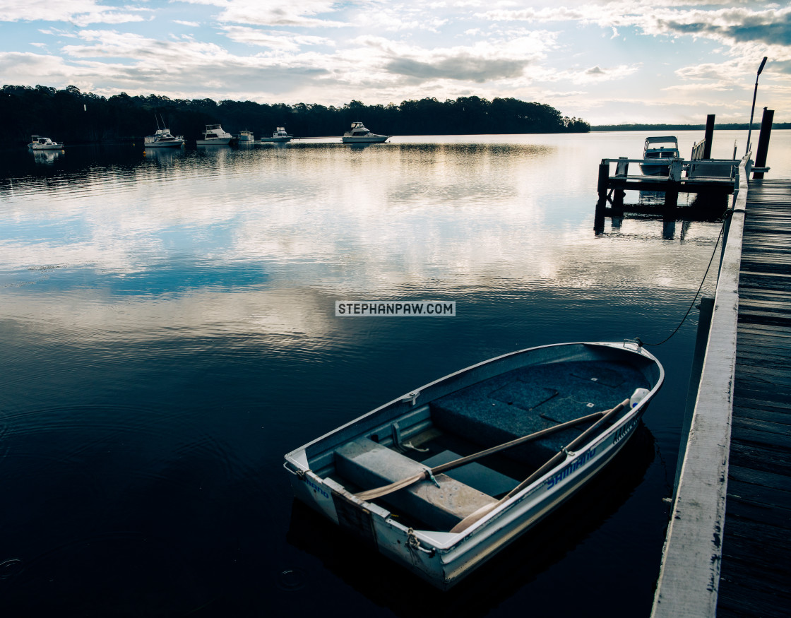 "Dinghy and jetty off Coomba Park // Wallis Lake, NSW" stock image