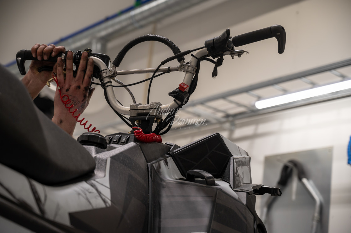 "Mechanic repairing snowmobile" stock image