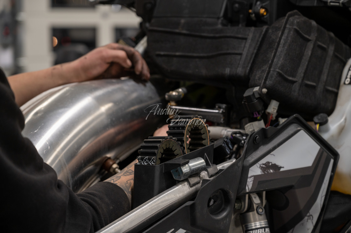 "Mechanic repairing snowmobile" stock image