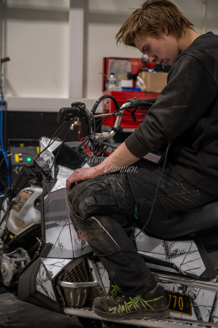 "Mechanic repairing a snowmobile" stock image