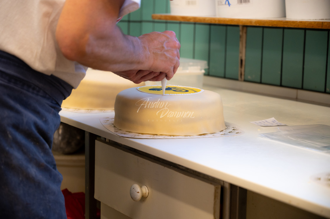 "Cake being decorated" stock image