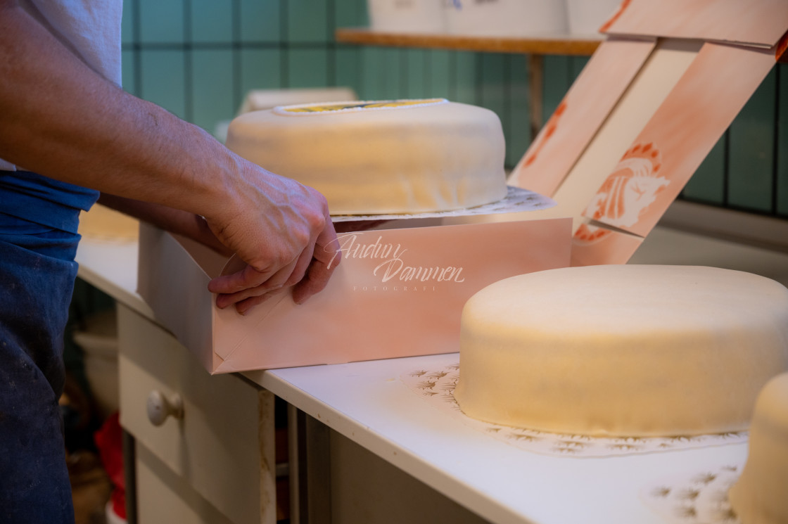 "Cake being placed in a box" stock image