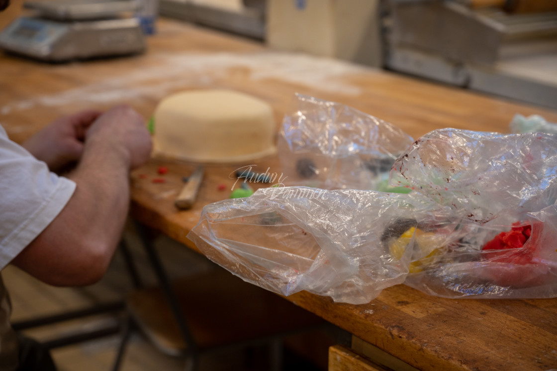 "Cake being decorated" stock image