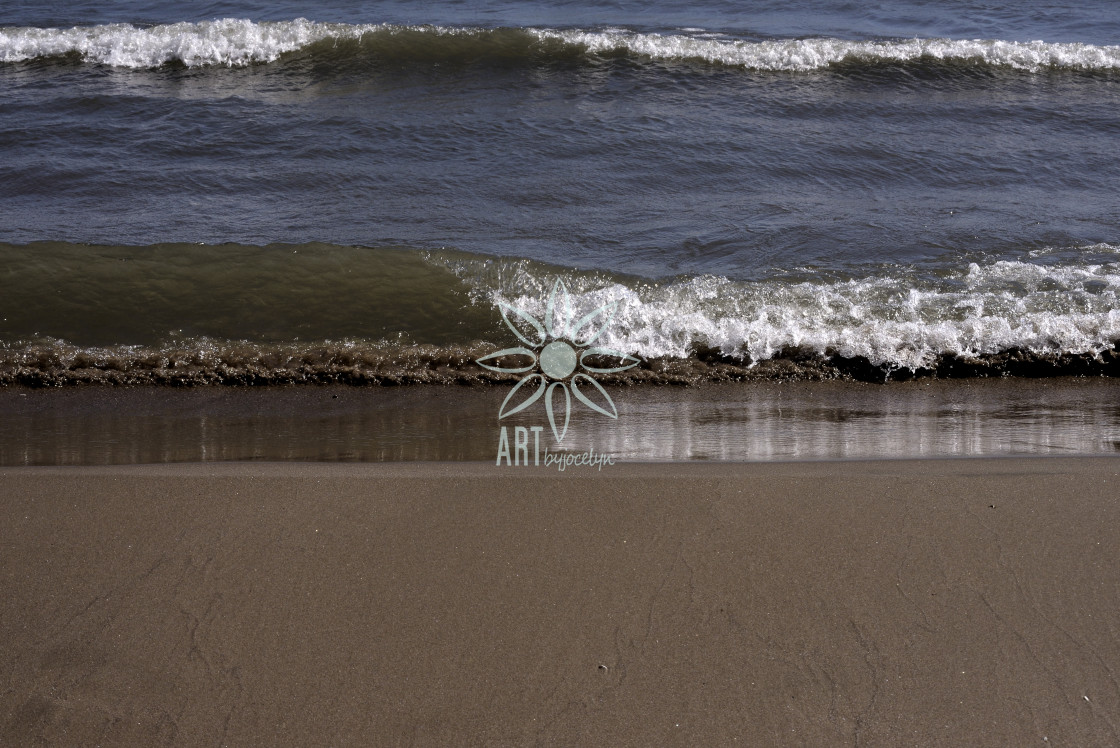 "Wave Reflections on Sandy Beach Shore" stock image