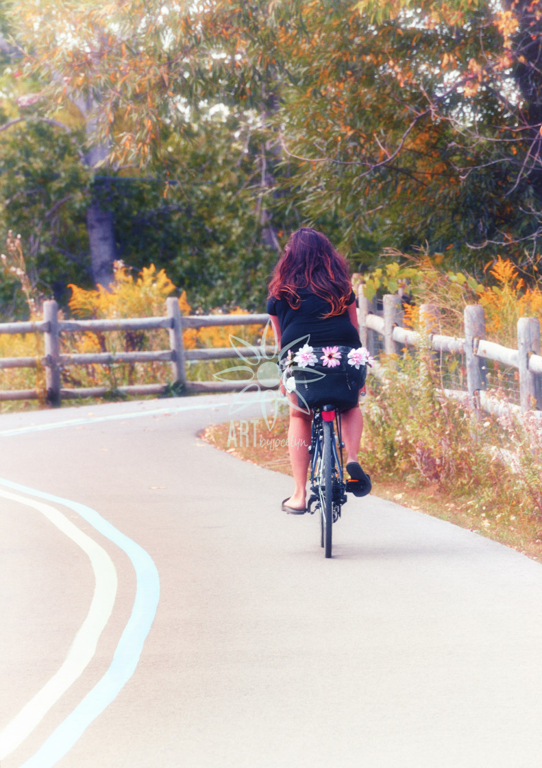 "Girl Riding Bike with Flowers" stock image