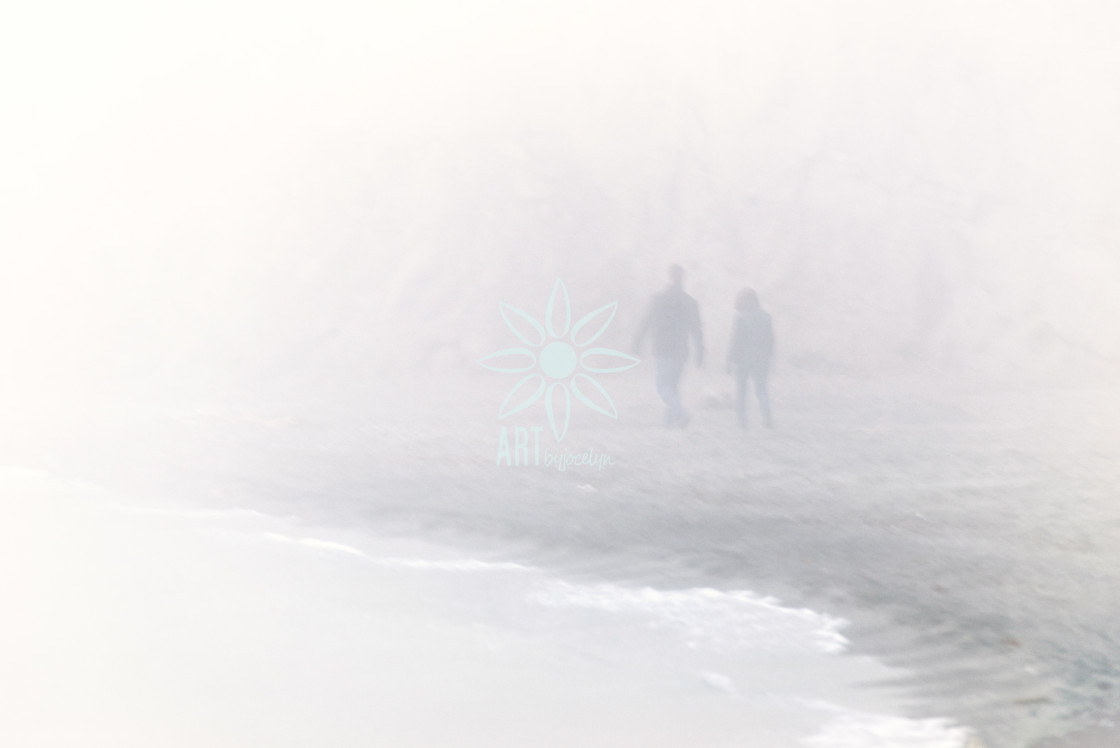 "Couple Walking on Foggy Beach in Winter" stock image