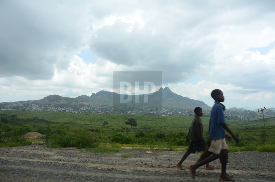 "Children walking along a road in Malawi" by Brendan Howard - £10.00 "Children walking along a road in Malawi" stock image