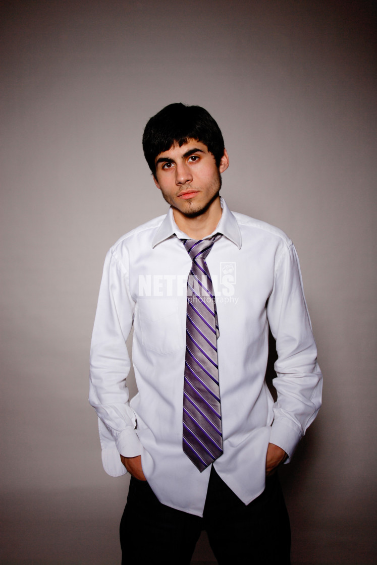 "Businessman putting on tie" stock image